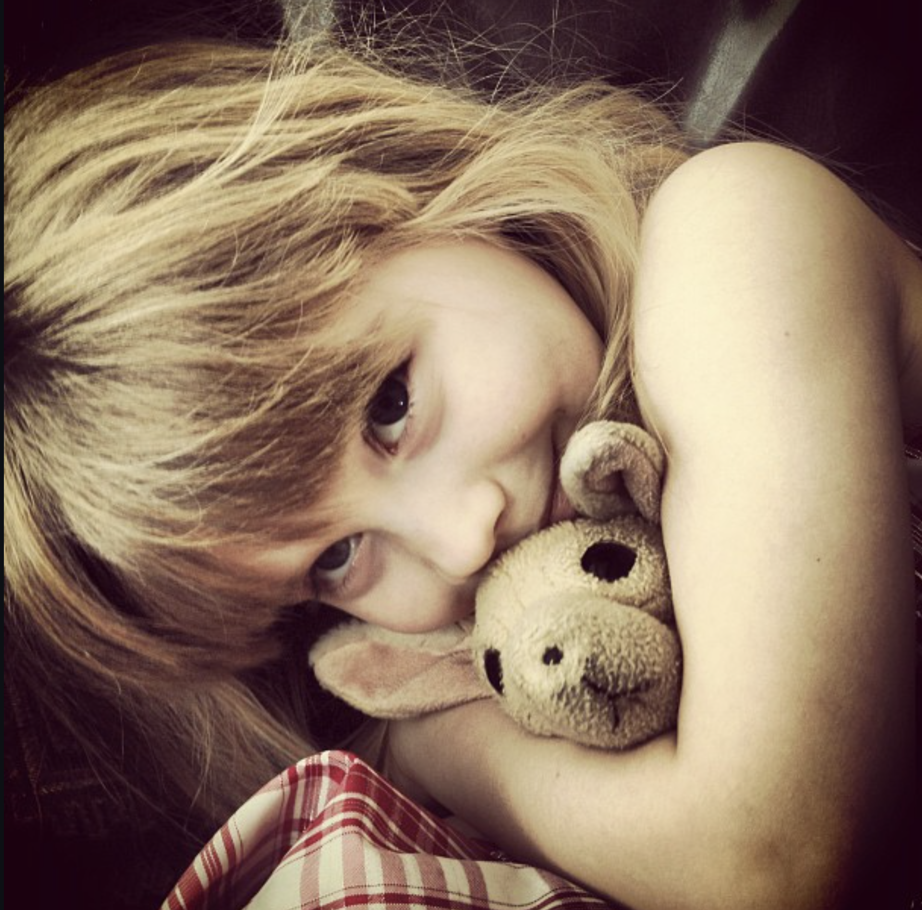 Rachel cuddling a stuffed puppy dog